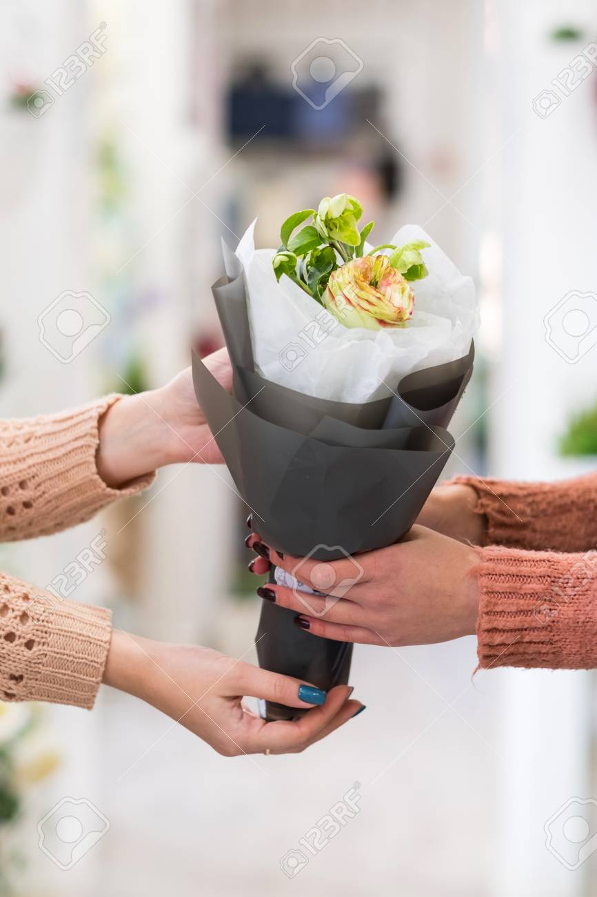 women holding bouquet of roses and jasmine in craft paper flower paper flower delivery