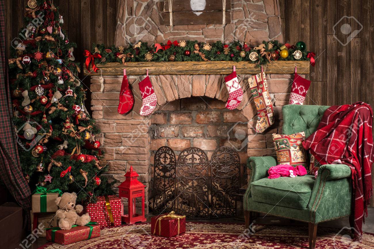 Interior Christmas room: fireplace, chair and tree - 62318294 Interior Christmas room: fireplace, chair and tree - 62318294