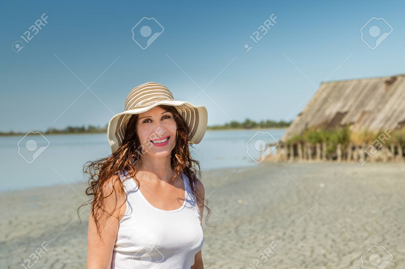 Attractive Mature Busty Woman In Very Good Shape With Wide Hat On A Sun Split Beach Attractive Mature Busty Woman In Very Good Shape With Wide Hat On A Sun Split Beach