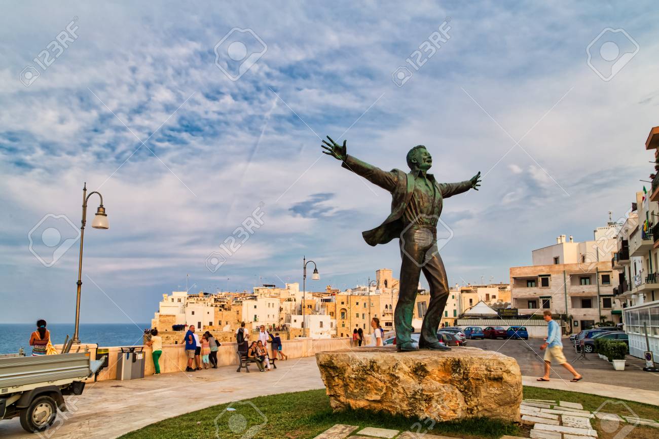 Polignano Ba Italy August 31 2016 The Tourists Gather Under The Statue Of Domenico Modugno To Sing Volare And His Other Songs Stock Photo Picture And Royalty Free Image Image 97672294