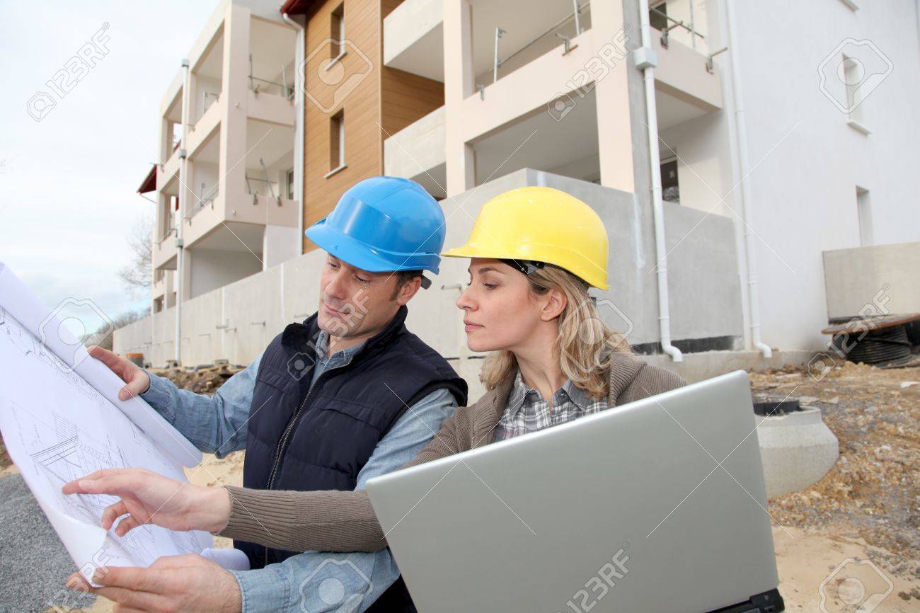architect and engineer looking at plan on construction site stock architect and engineer looking at plan on construction site stock