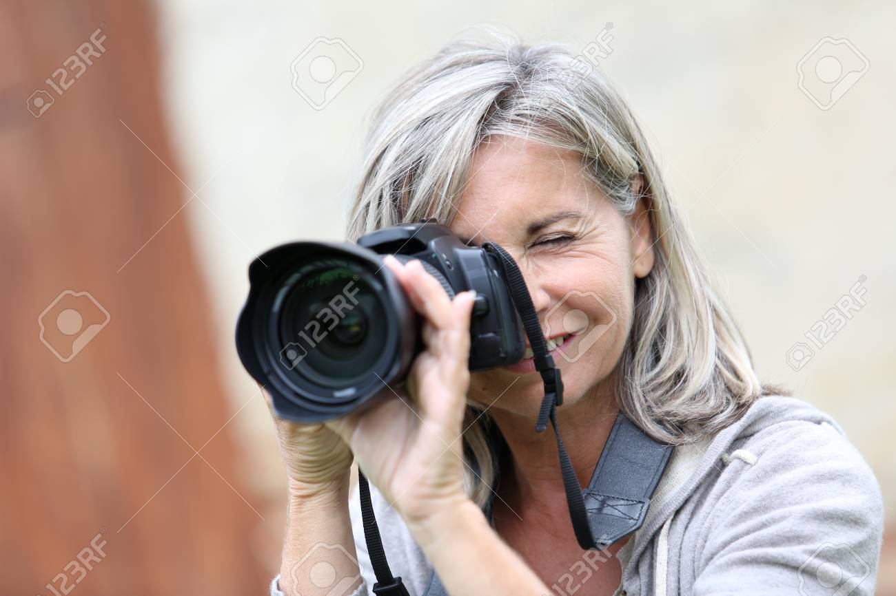 Mature Woman Shooting With Photo Camera