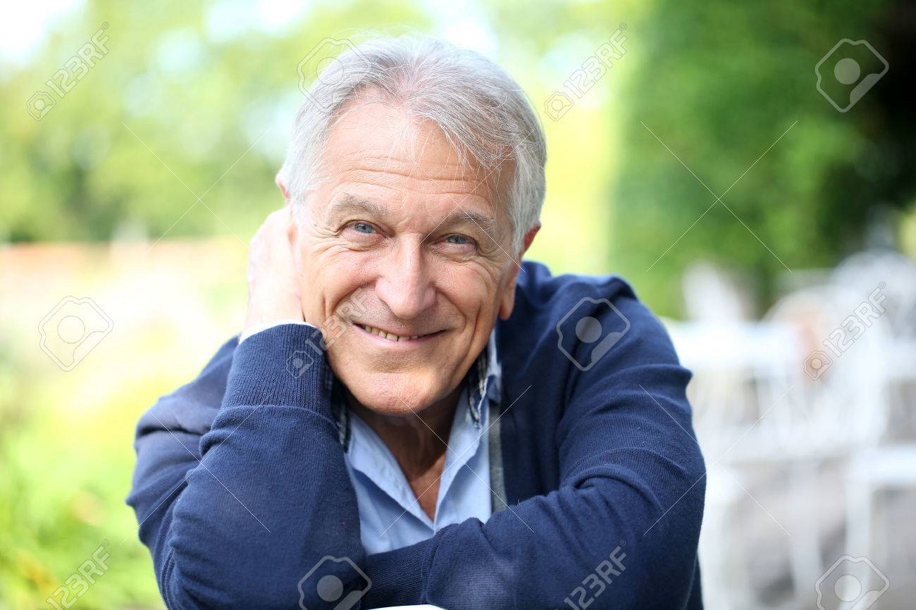 Portrait of senior man sitting in home garden - 31780453 Portrait of senior man sitting in home garden - 31780453