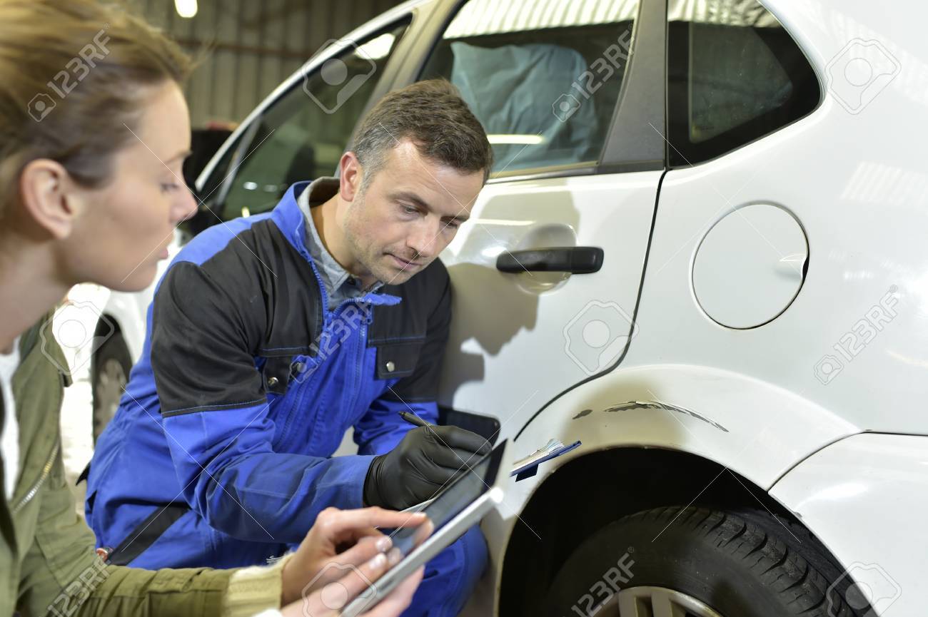 mechanician with insurance adjuster checking on auto repair stock automotive insurance adjuster