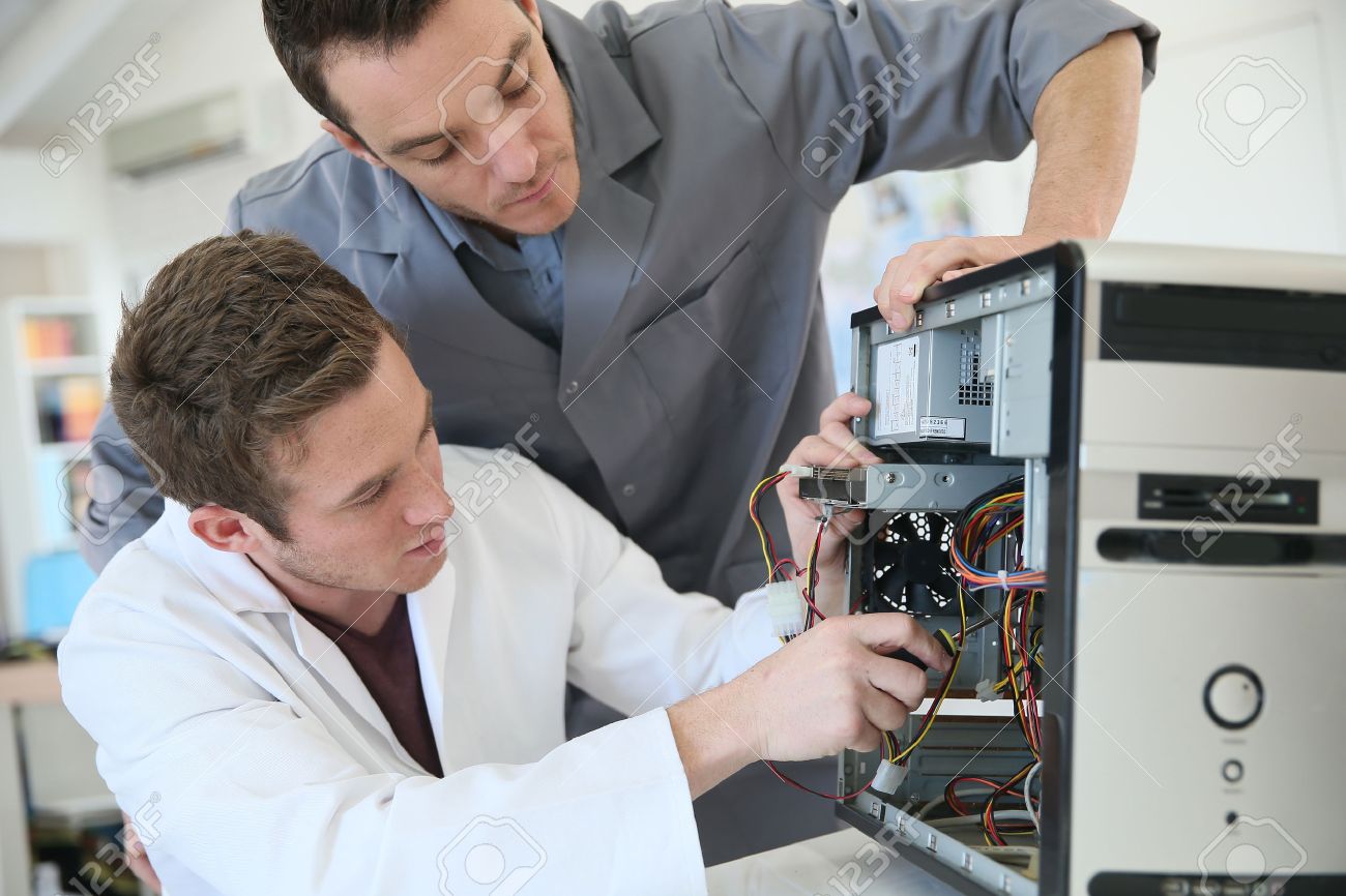 Young Adults Fixing Computer Hardware In Technology School Stock ... Young Adults Fixing Computer Hardware In Technology School Stock ...