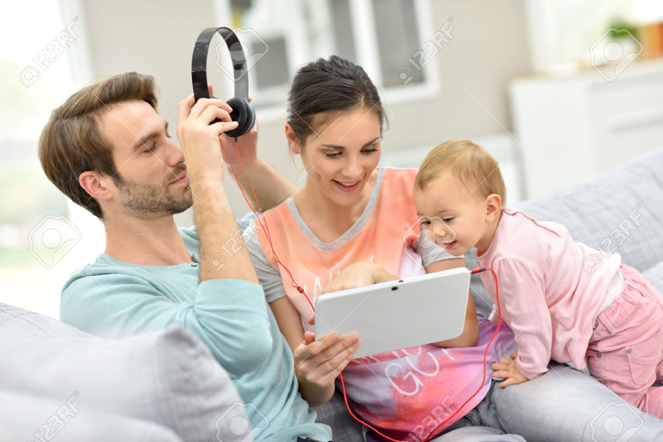 Couple Avec Bebe Dans Le Canape En Regardant Le Film Sur Tablette Banque D Images Et Photos Libres De Droits Image