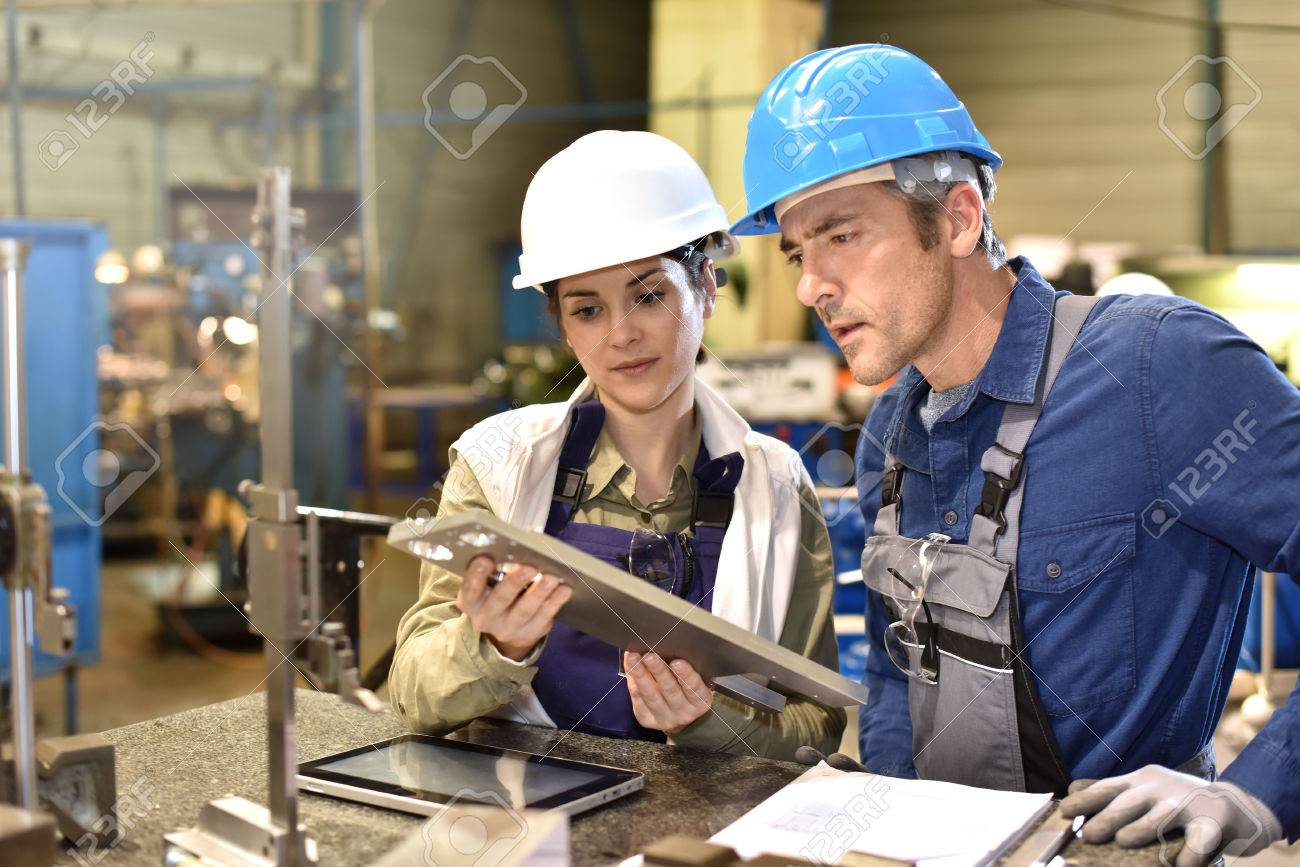 Metallurgy workers in workshop using digital tablet - 50631052 Metallurgy workers in workshop using digital tablet - 50631052