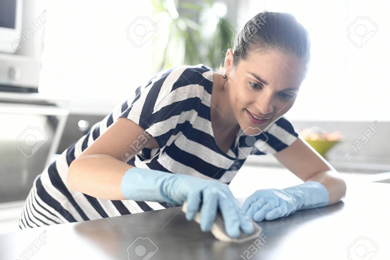 Cleaning lady washing kitchen table - 62339206 Cleaning lady washing kitchen table - 62339206