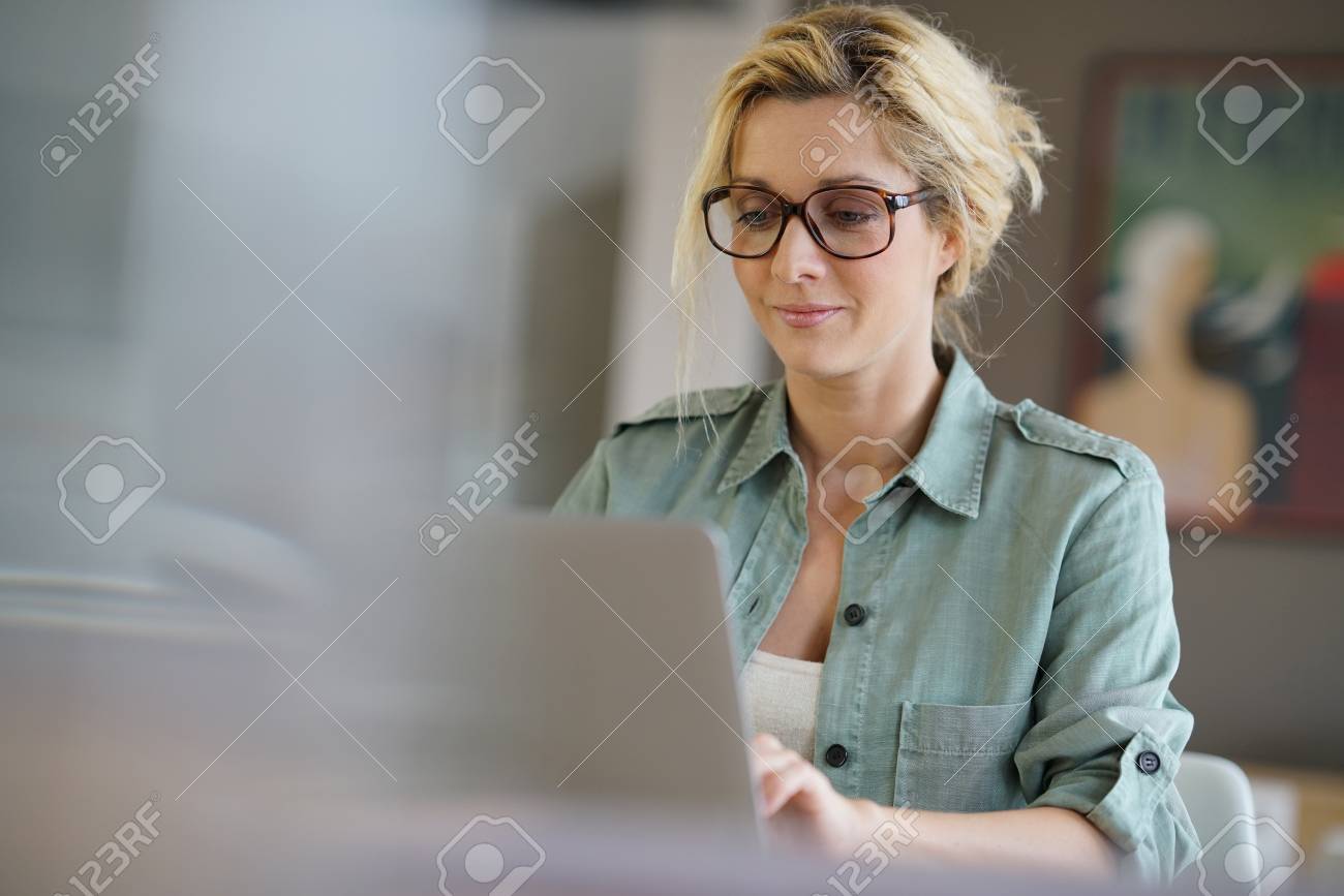 Portrait of blond woman working from home on laptop computer - 71634240 Portrait of blond woman working from home on laptop computer - 71634240