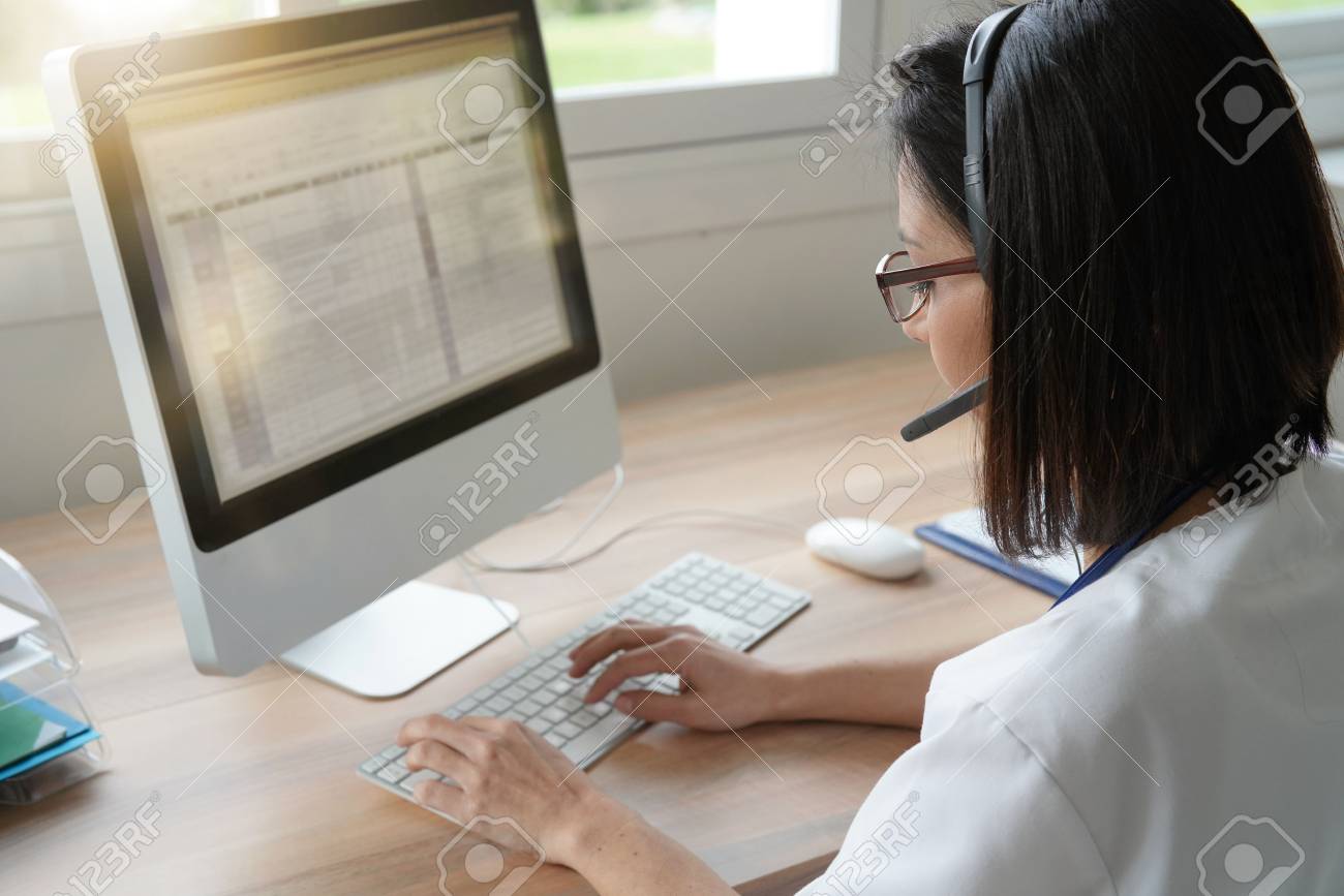 Medical secretary typing report on deskop computer Stock Photo - 97145481