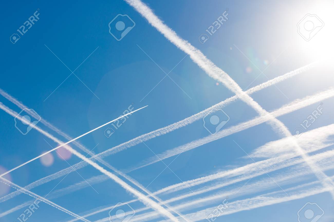 airplanes in blue sky with vapor trail condensation trails of vapor trails