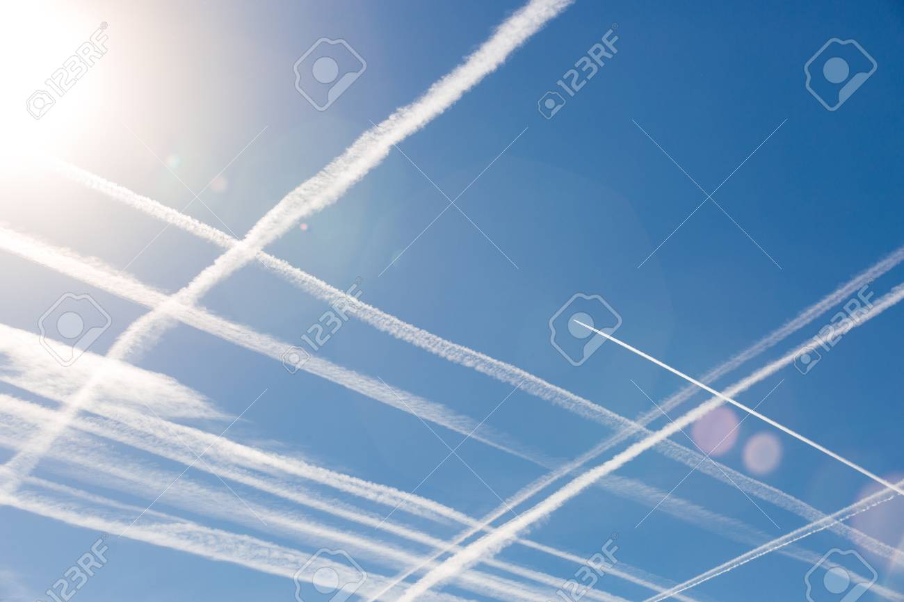 airplanes in blue sky with vapor trail condensation trails of vapor trails
