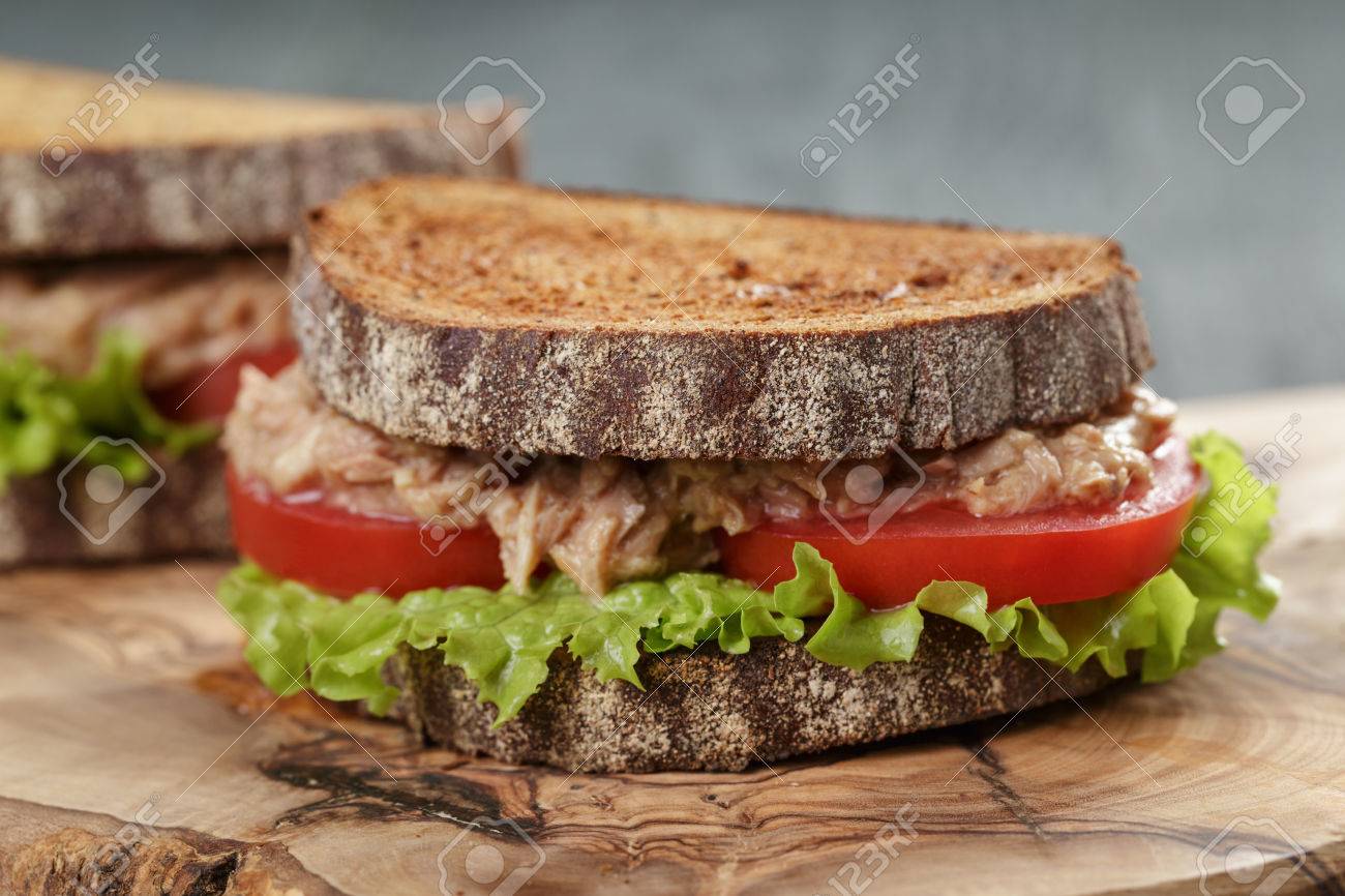 Sandwich with tuna and vegetables on rye bread on wood background - 42780294 Sandwich with tuna and vegetables on rye bread on wood background - 42780294