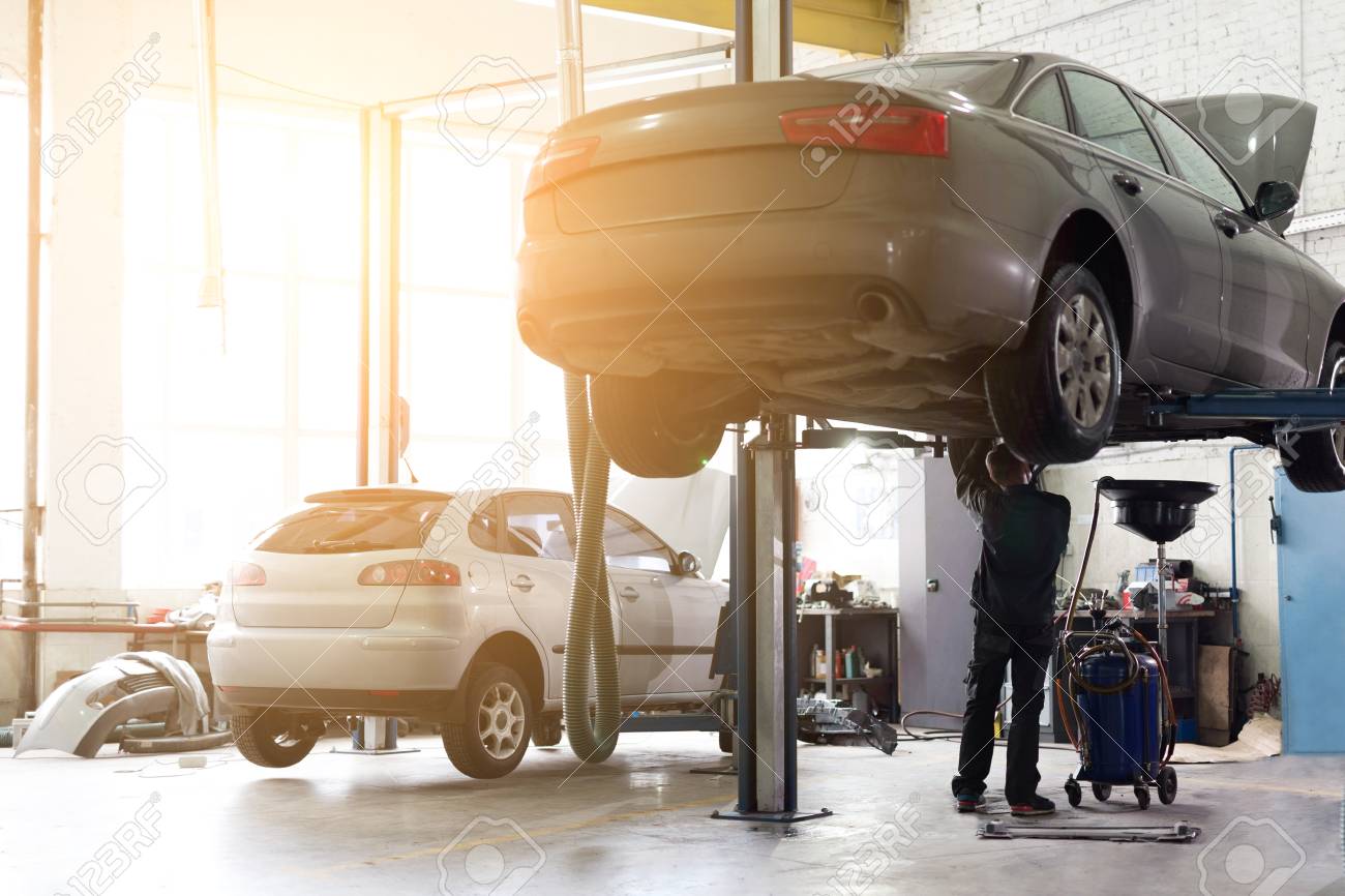 Car Service Center Vehicle Raised On Lift At Maintenance Station Auomobile Repair And Check Up Stock Photo Picture And Royalty Free Image Image 113436053