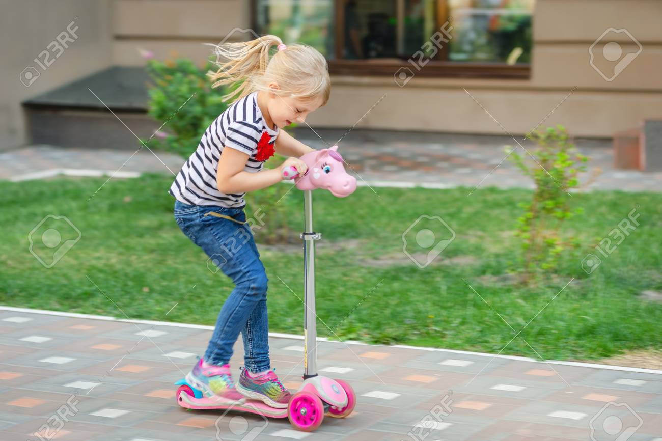 little girl riding scooter