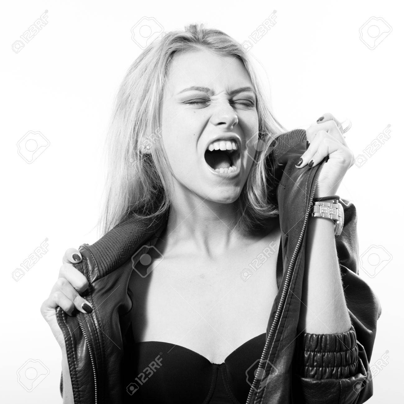 Black and white portrait of eyes closed sexy young blonde woman posing emotionally singing or screaming