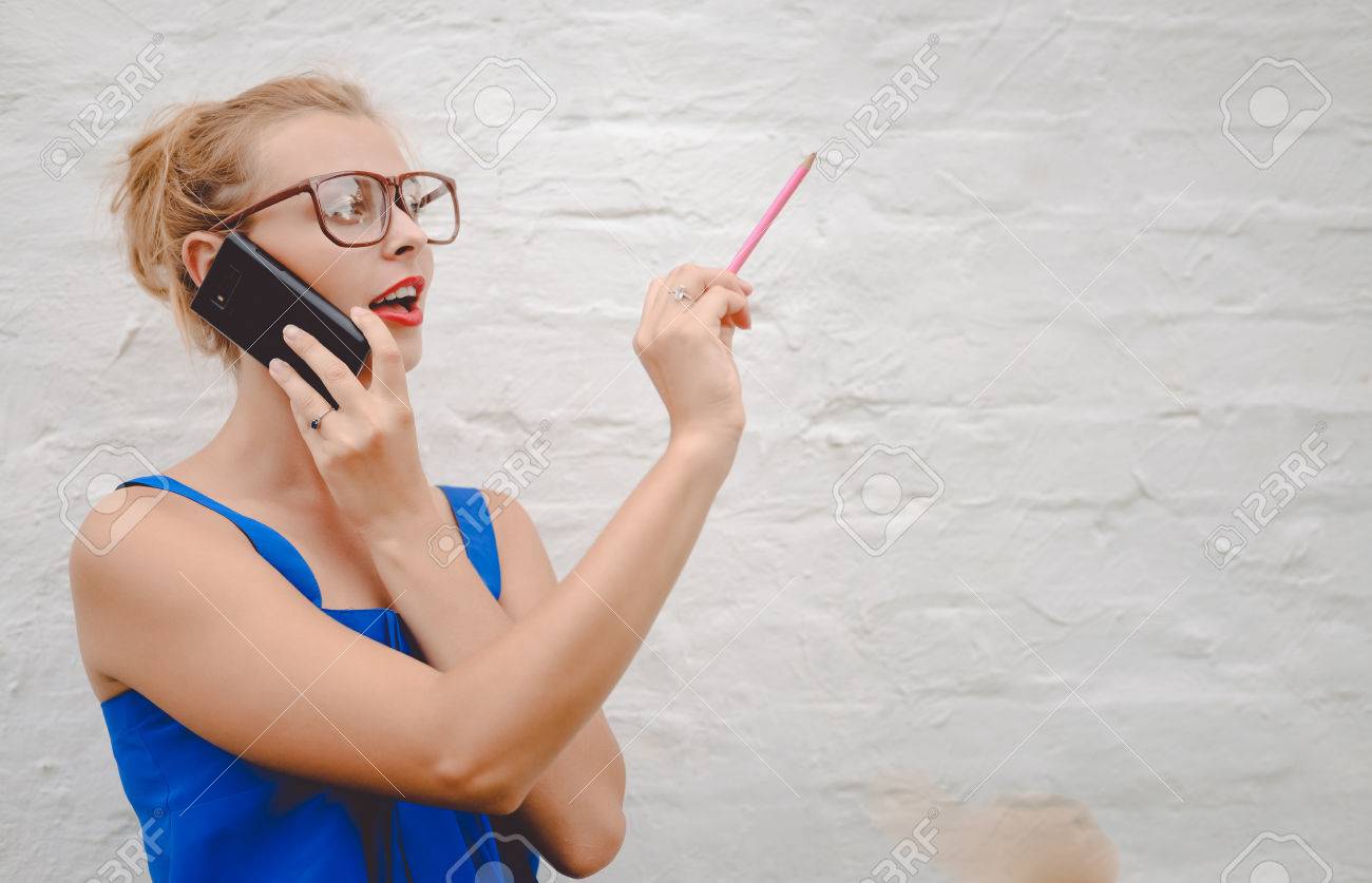 Portrait Of Pretty Woman In Big Glasses Speaking Phone And Drawing