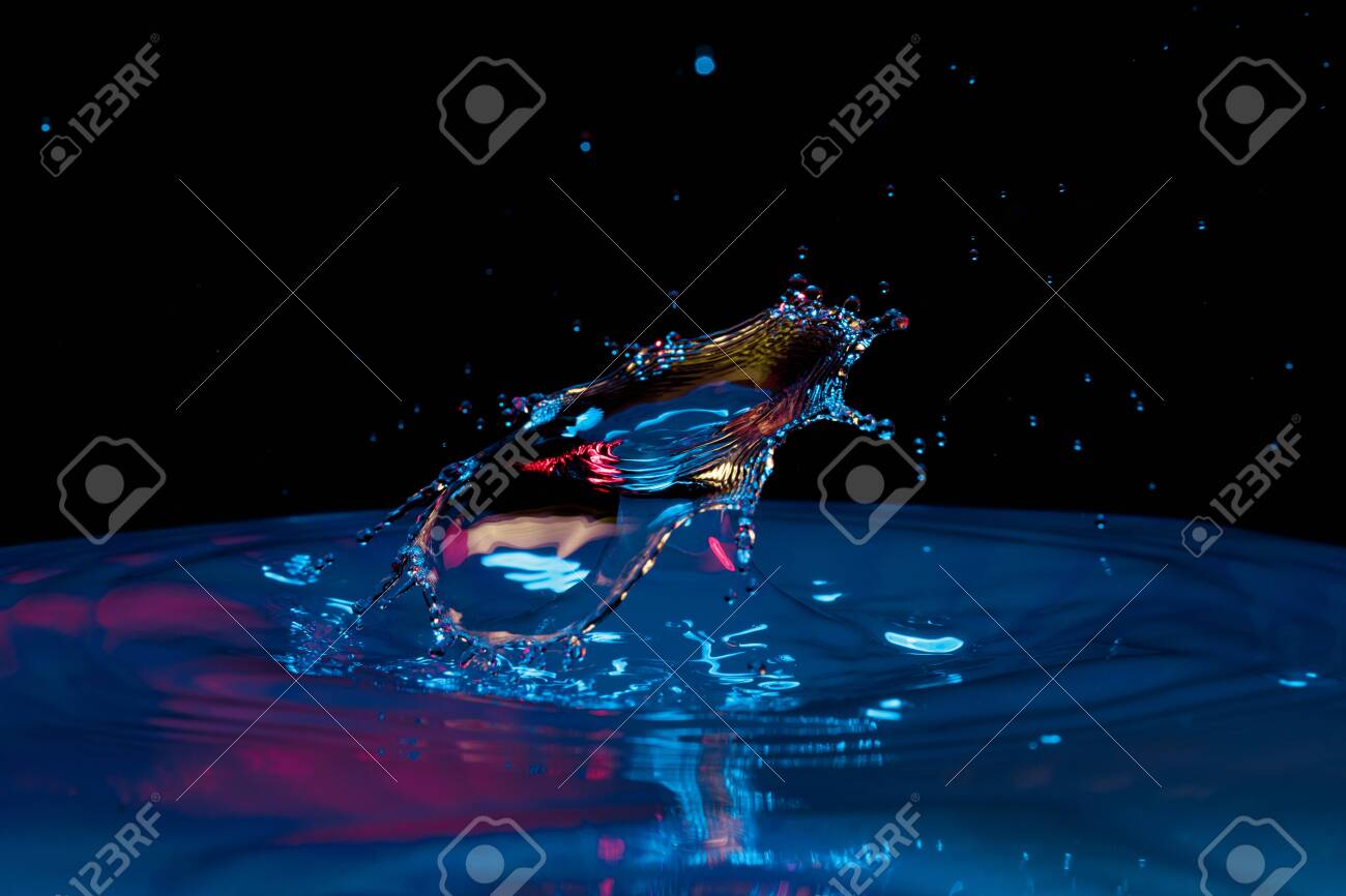 drop of water falling down in the water - 129475780 drop of water falling down in the water - 129475780