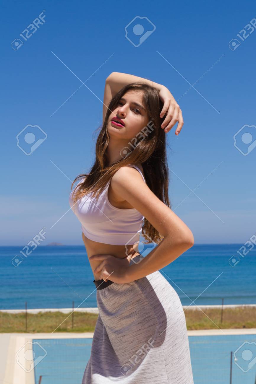Morena De Pelo Largo Chica Joven Magnífica Tetona Adolescente En Traje De  Ropa Deportiva Disfrutando De Una Mañana De Primavera Fresca Por El Océano.  Fotos, retratos, imágenes y fotografía de archivo libres