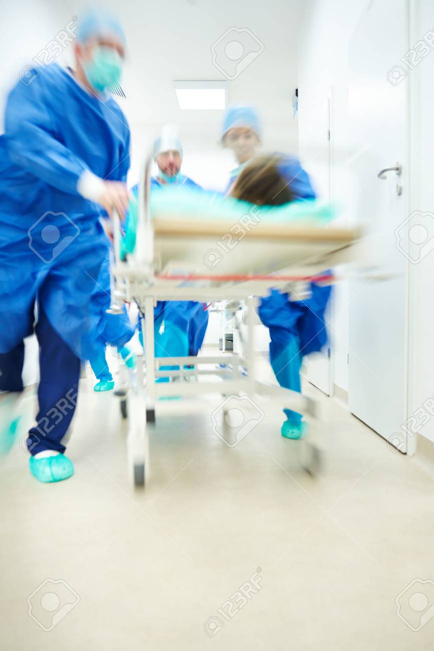 Doctors running to the operating room - 71063830 Doctors running to the operating room - 71063830