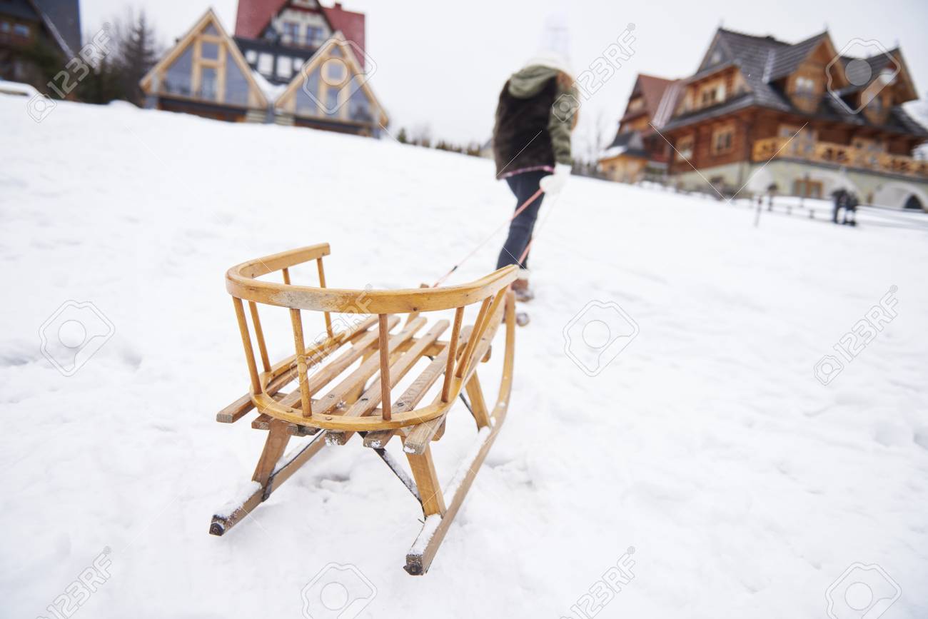 man pulling sleigh up the hill stock photo picture and royalty free