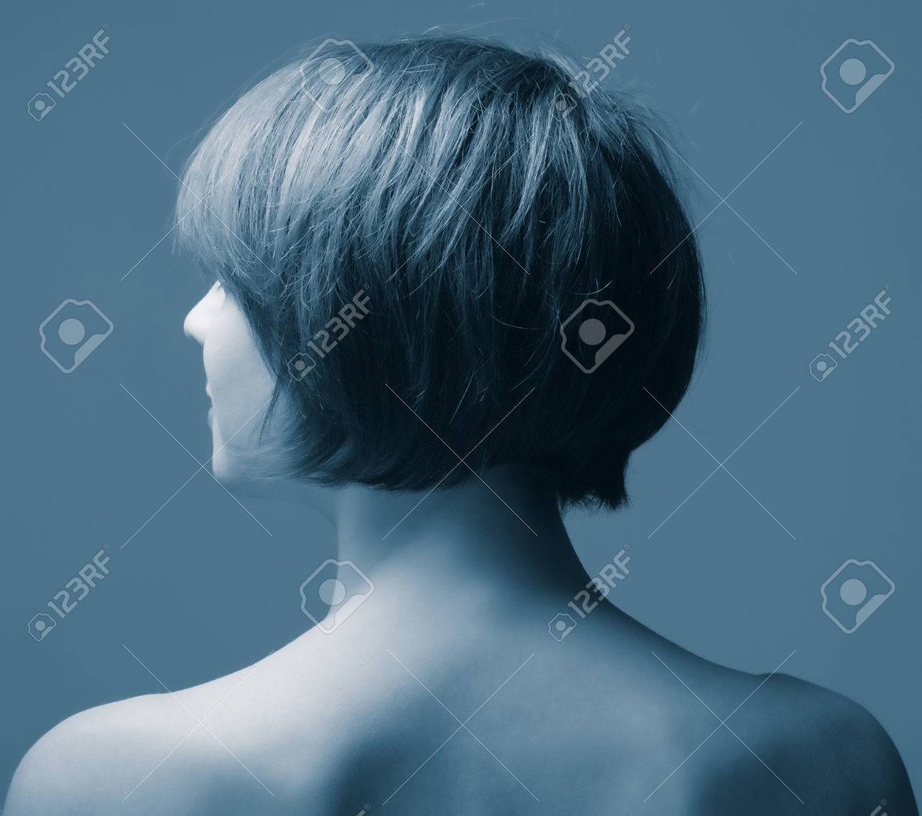 Head Of A Woman With Short Hair From The Back On A Dark Background
