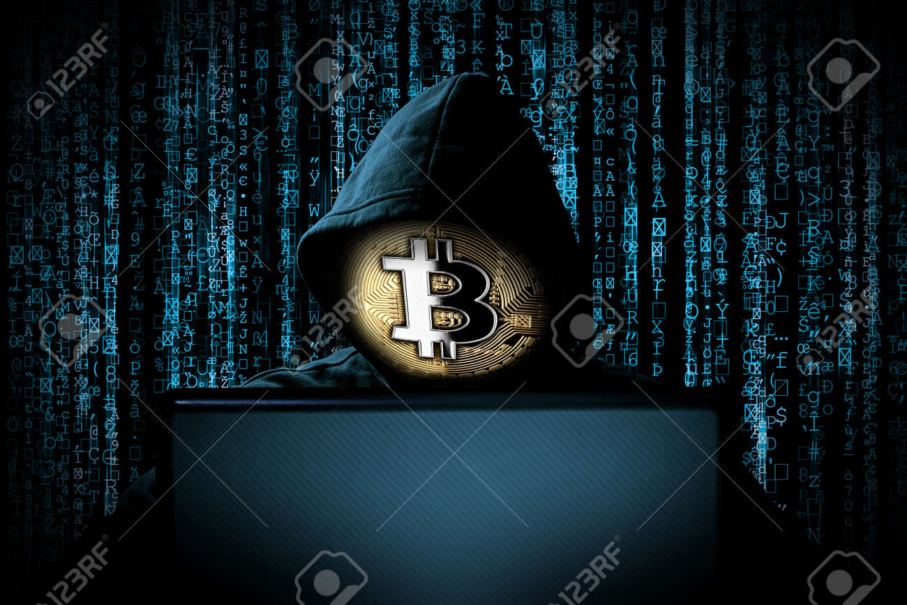 Hacker Con Máscara Facial De Bitcoin Detrás De Una Computadora Portátil  Frente A Un Fondo De Código Binario De Fuente Azul Internet Ataque  Cibernético Concepto De Computadora Blockchain De Moneda Criptográfica  Fotos,