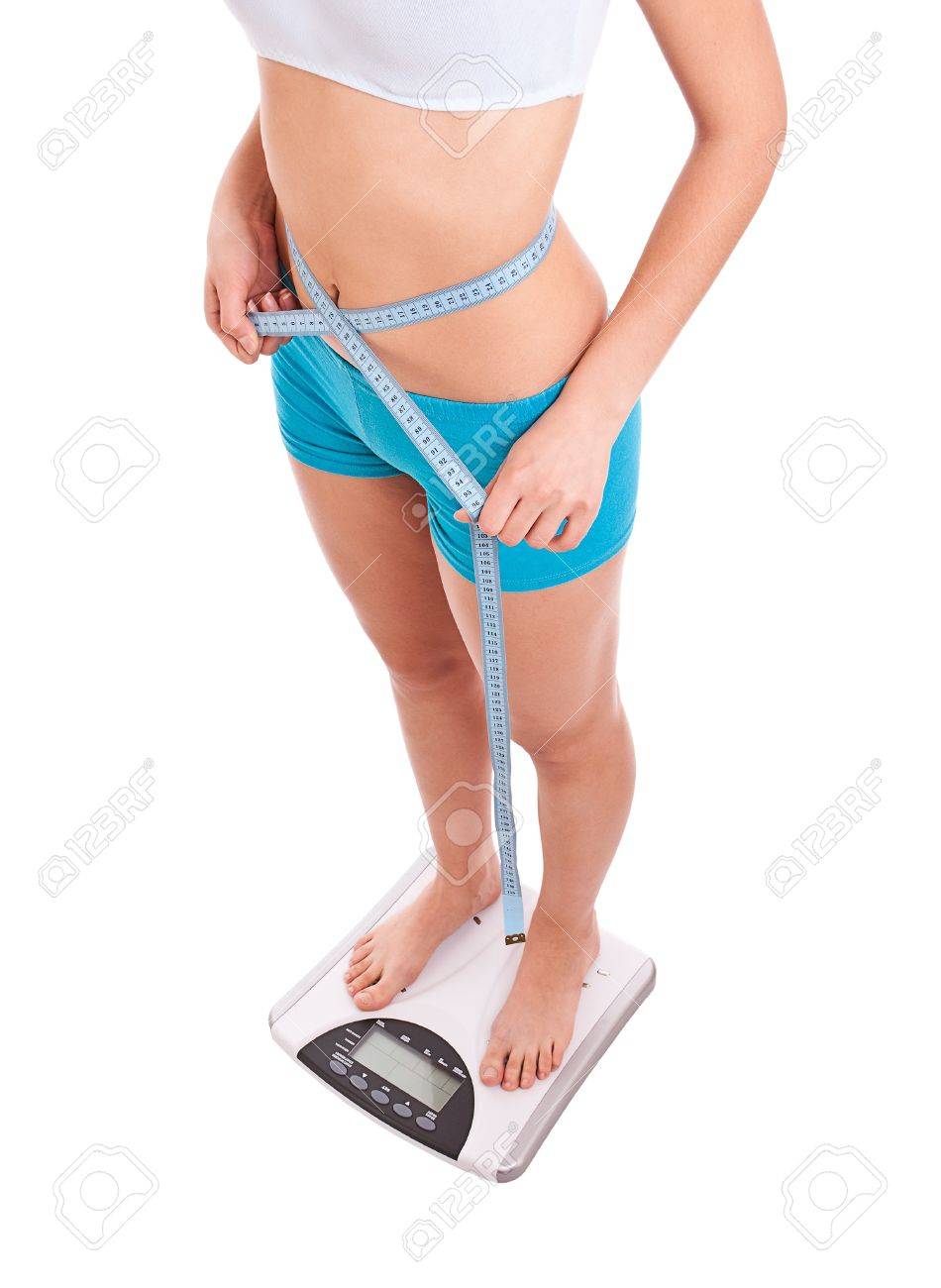woman on scale measures her weight loss progress stock photo measures for weight loss