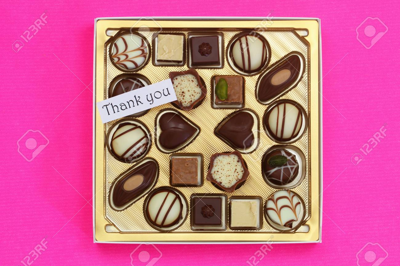 thank you card with box of assorted chocolates on pink background