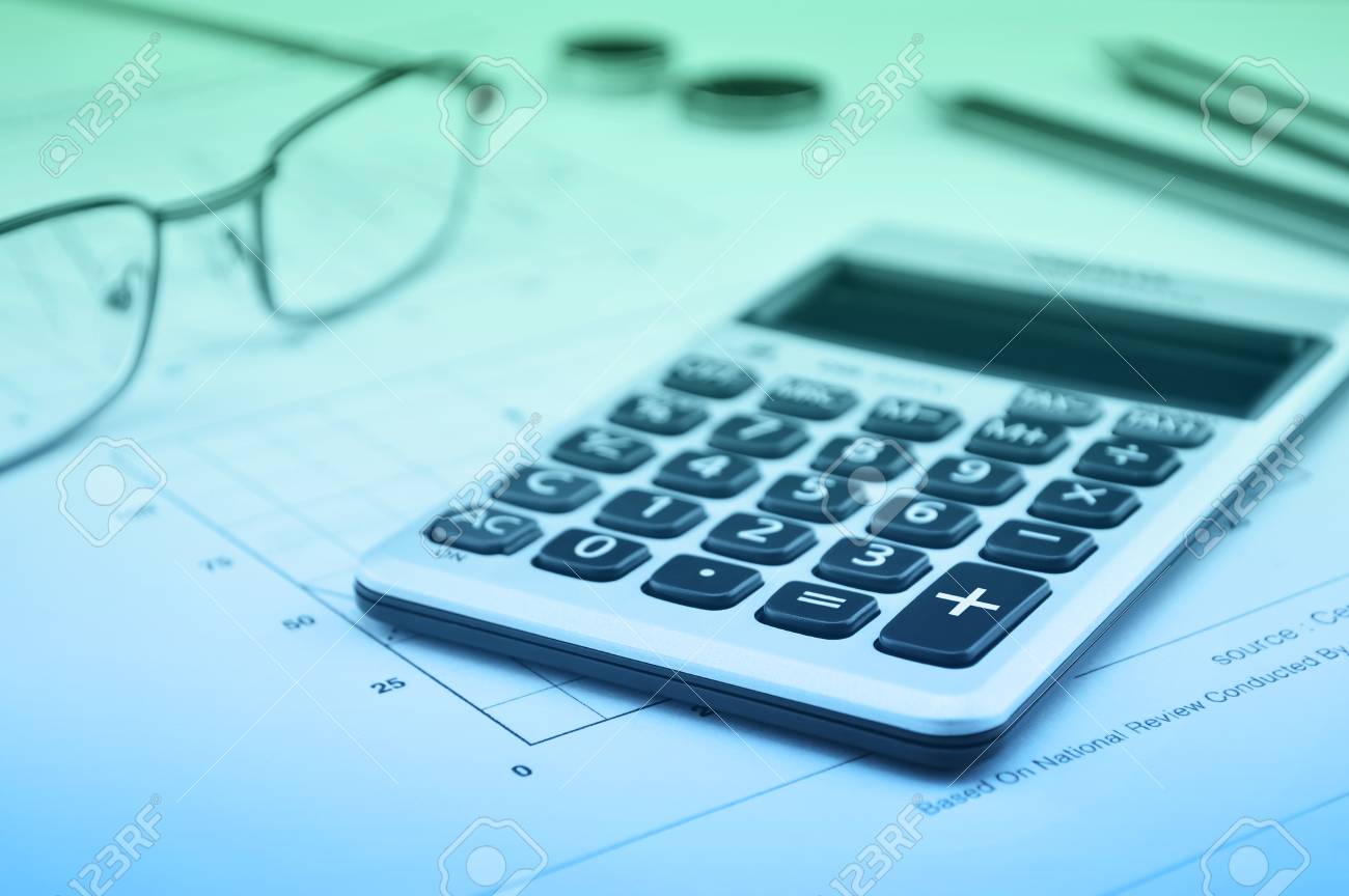calculator button plus glasses coin pencil and mouse on graph national graph paper