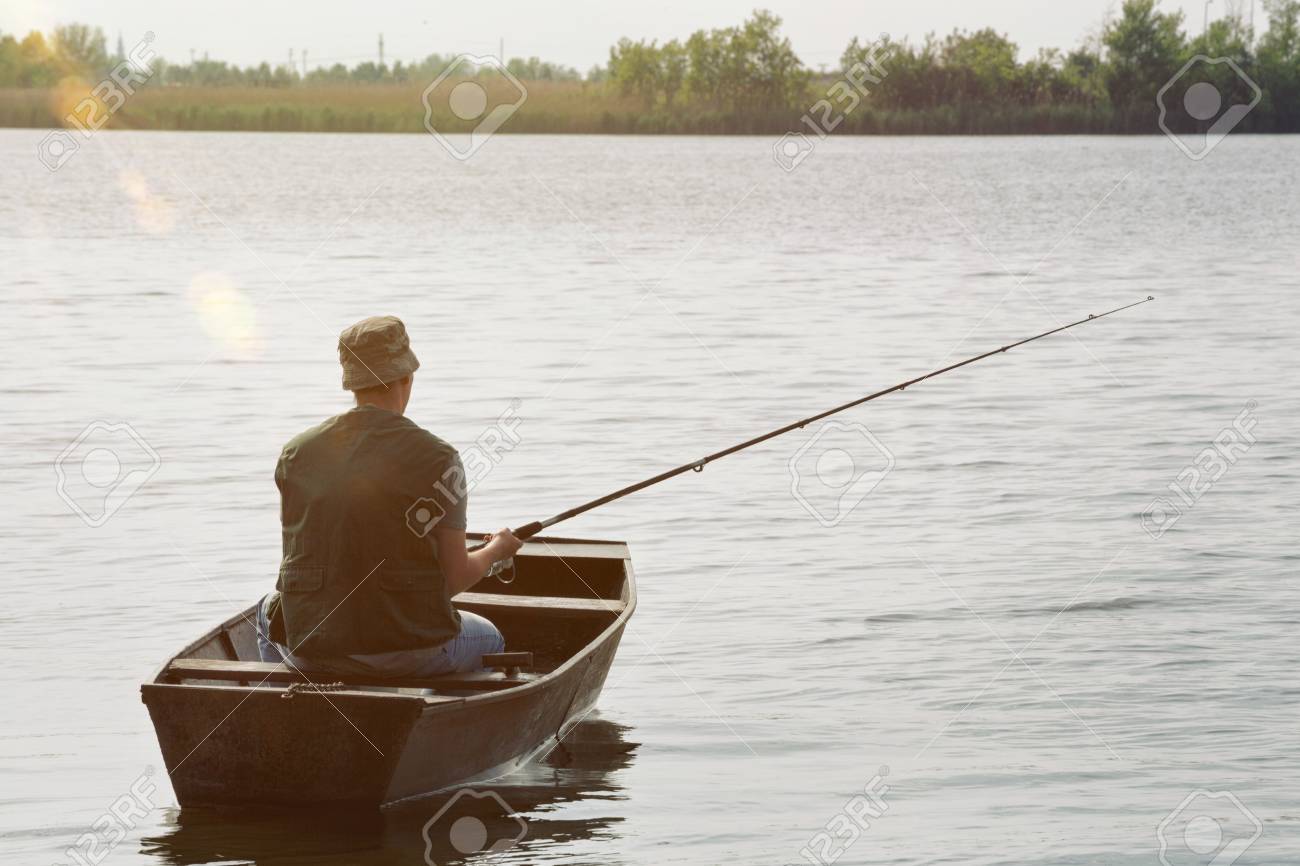 Fisherman Fishing Man Catching Fish In Boat Stock Photo Picture And