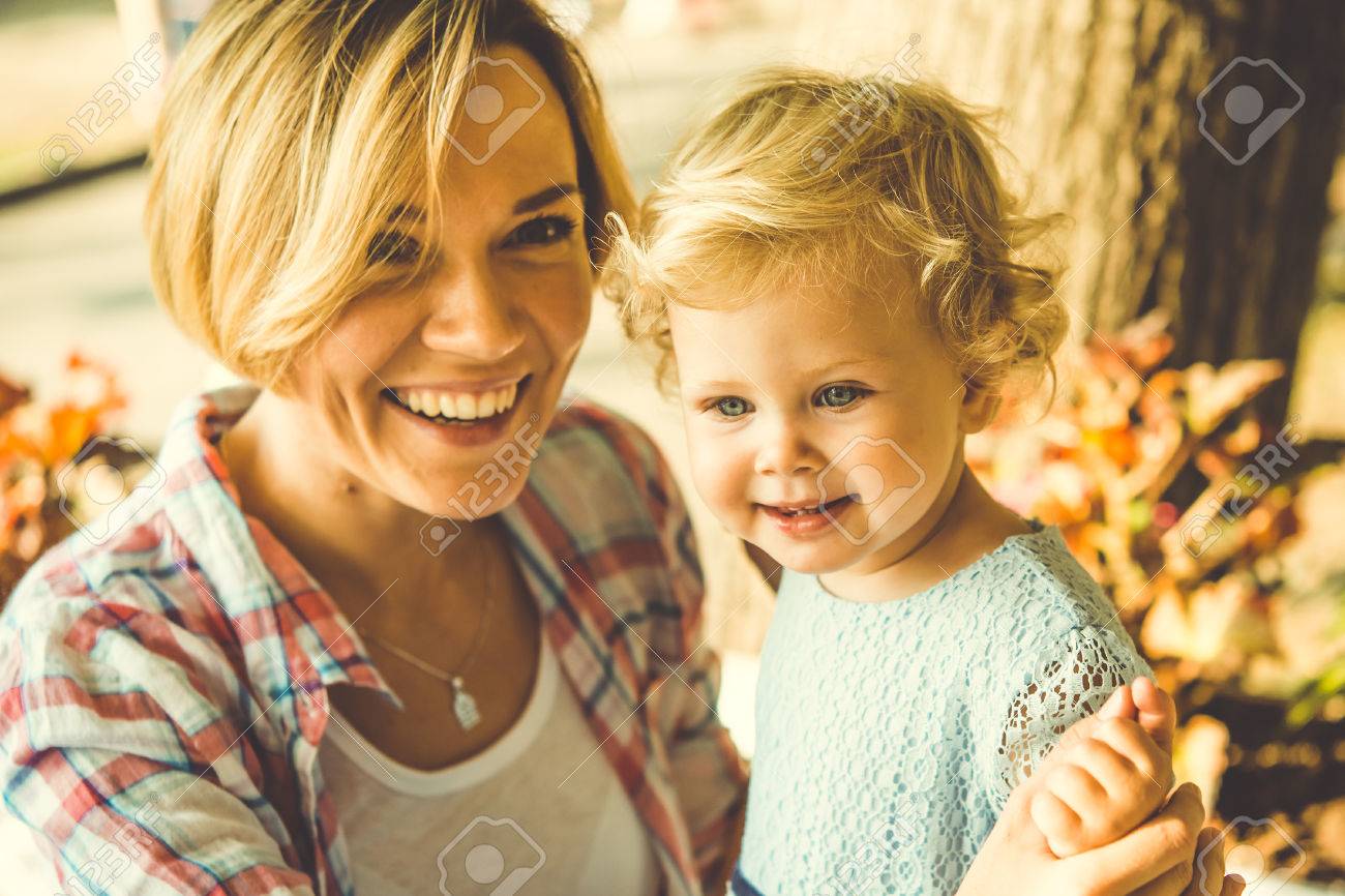 Young beautiful blonde mother with her little daughter. Toned image - 50842437 Young beautiful blonde mother with her little daughter. Toned image - 50842437