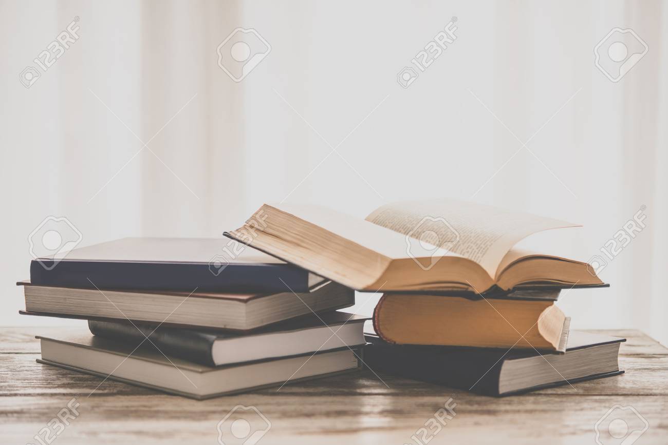 Pile of books on wooden table. Education and reading concept. Toned picture - 55411687 Pile of books on wooden table. Education and reading concept. Toned picture - 55411687