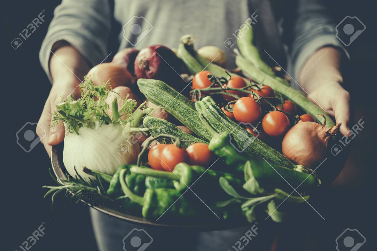 Hands holding big plate with different fresh farm vegetables. Autumn harvest and healthy organic food concept. Toned picture - 58513463 Hands holding big plate with different fresh farm vegetables. Autumn harvest and healthy organic food concept. Toned picture - 58513463