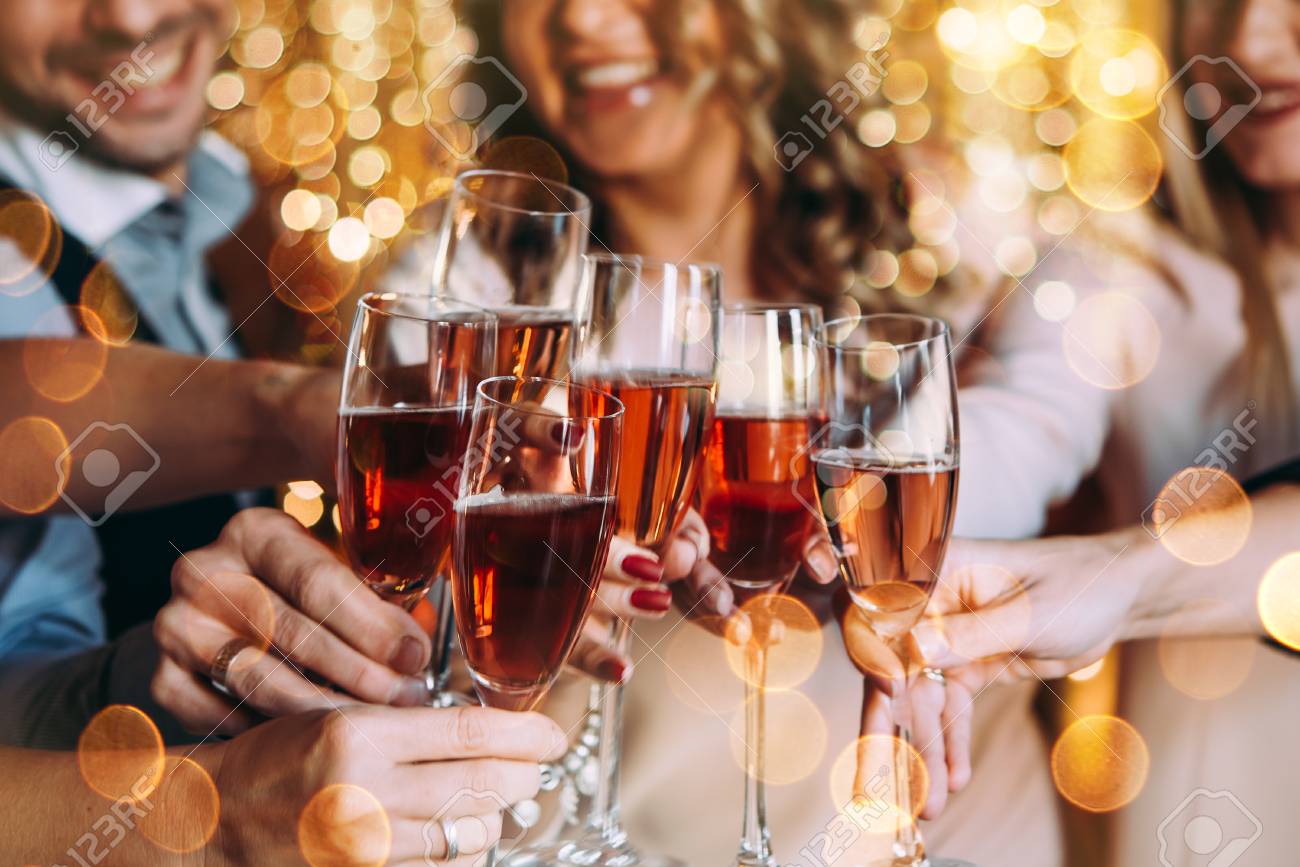 Friends celebrating Christmas or New Year eve with glasses of rose champagne - 89627388 Friends celebrating Christmas or New Year eve with glasses of rose champagne - 89627388