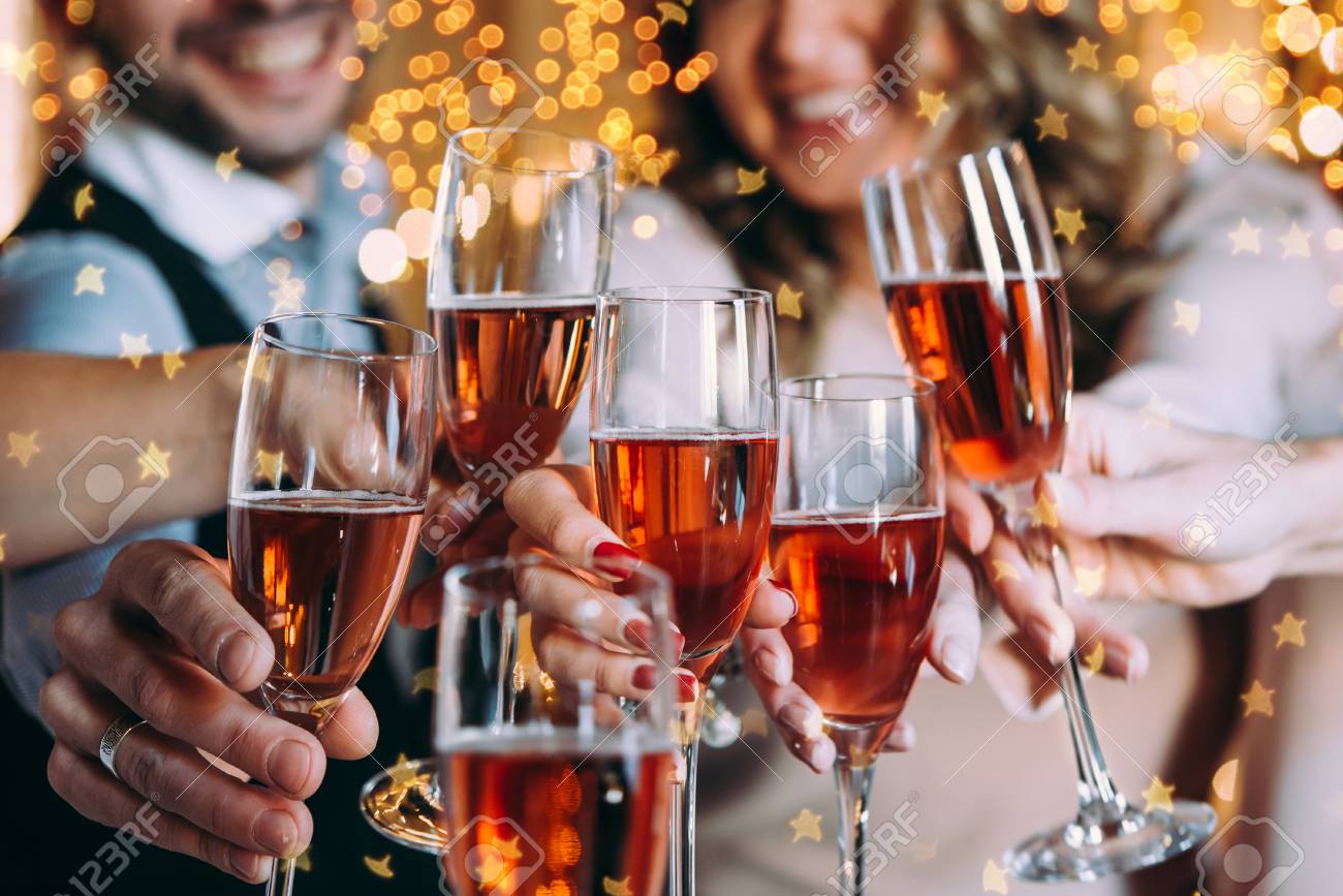 Friends celebrating Christmas or New Year eve with glasses of rose champagne - 90280766 Friends celebrating Christmas or New Year eve with glasses of rose champagne - 90280766