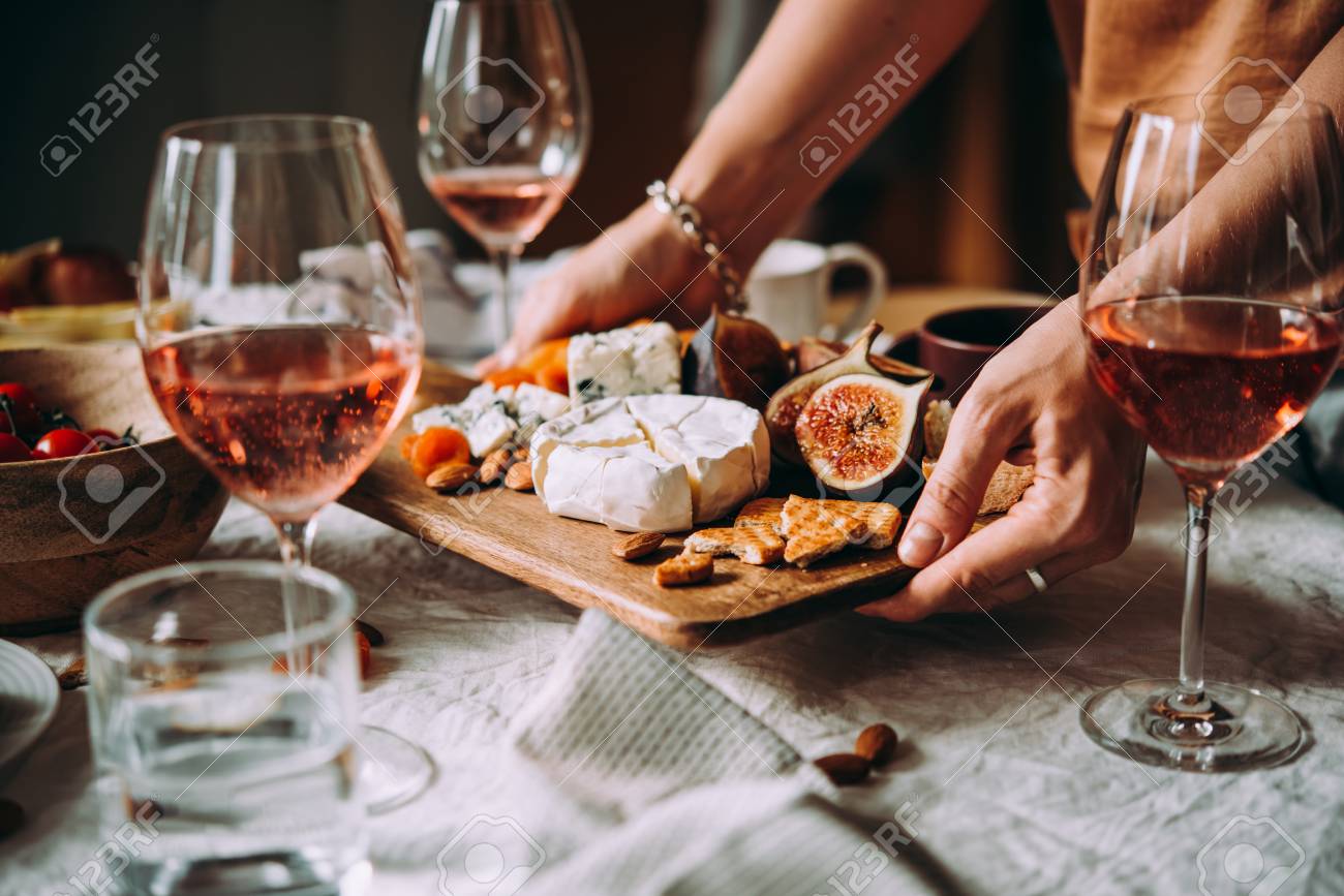 Offering appetizers at a friendly party. Dinner or aperitivo party concept. - 109931633 Offering appetizers at a friendly party. Dinner or aperitivo party concept. - 109931633