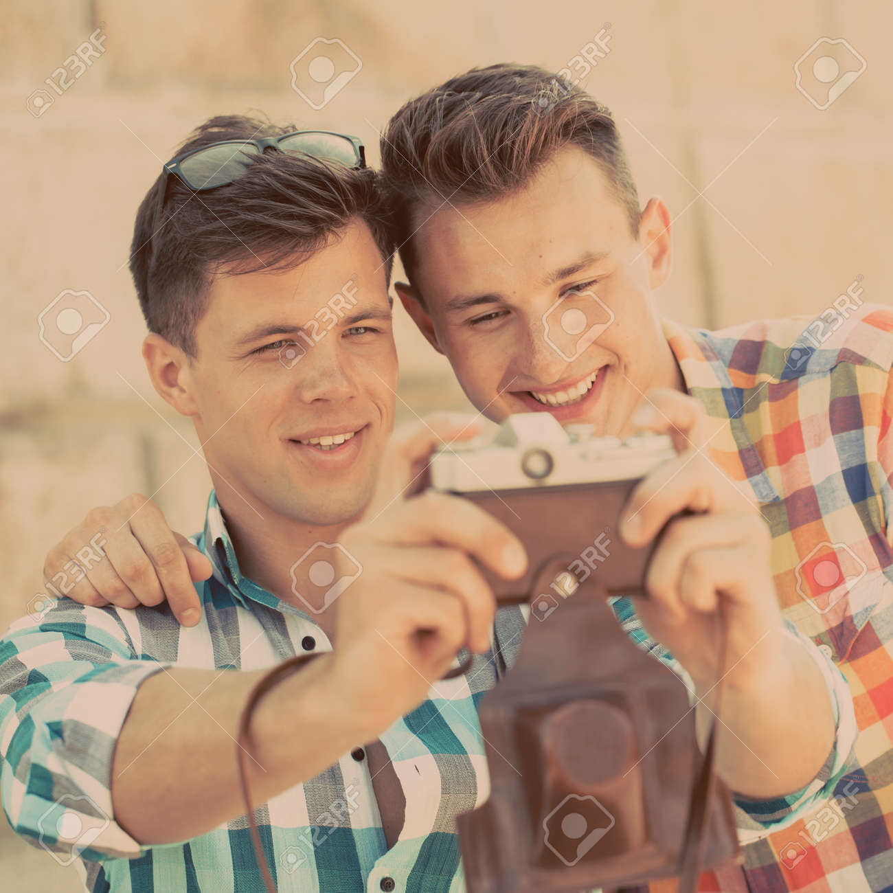 two guys photographing with retro photo camera stock photo picture