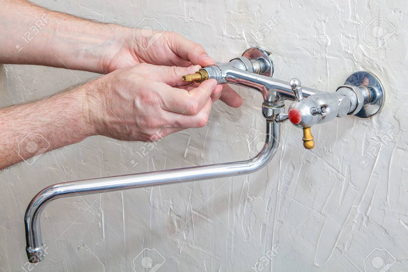 Plumber Fixing Water Tap With Leaking Water Double Handle Kitchen