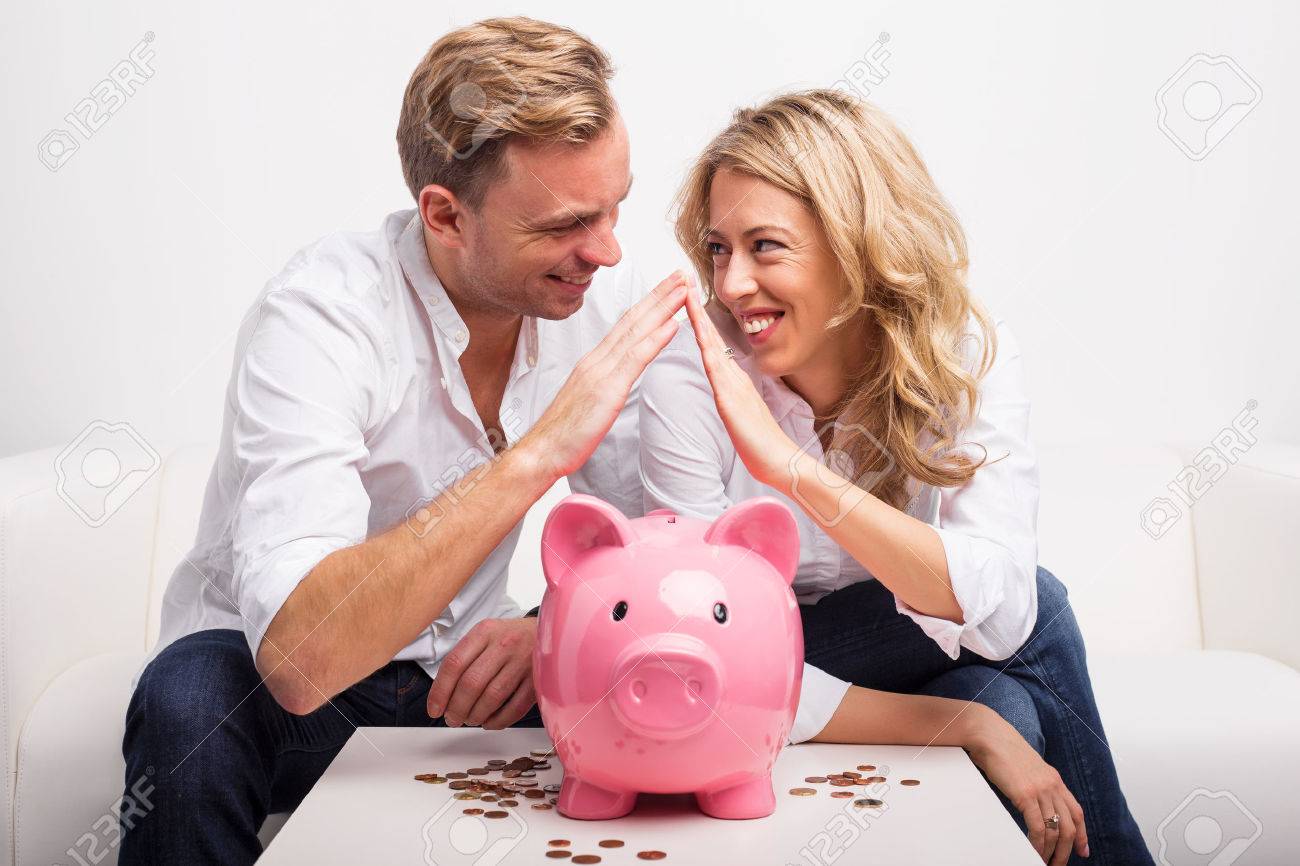 Couple saving money to buy house - 52935281 Couple saving money to buy house - 52935281