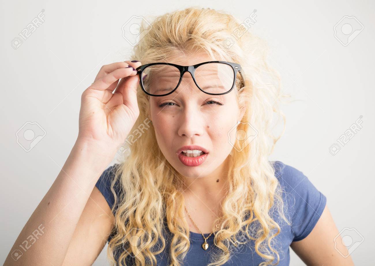 Woman with her glasses lifted up can't see - 75684630 Woman with her glasses lifted up can't see - 75684630