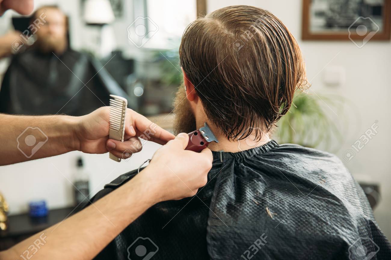 Bearded Man Having A Haircut With A Hair Clippers