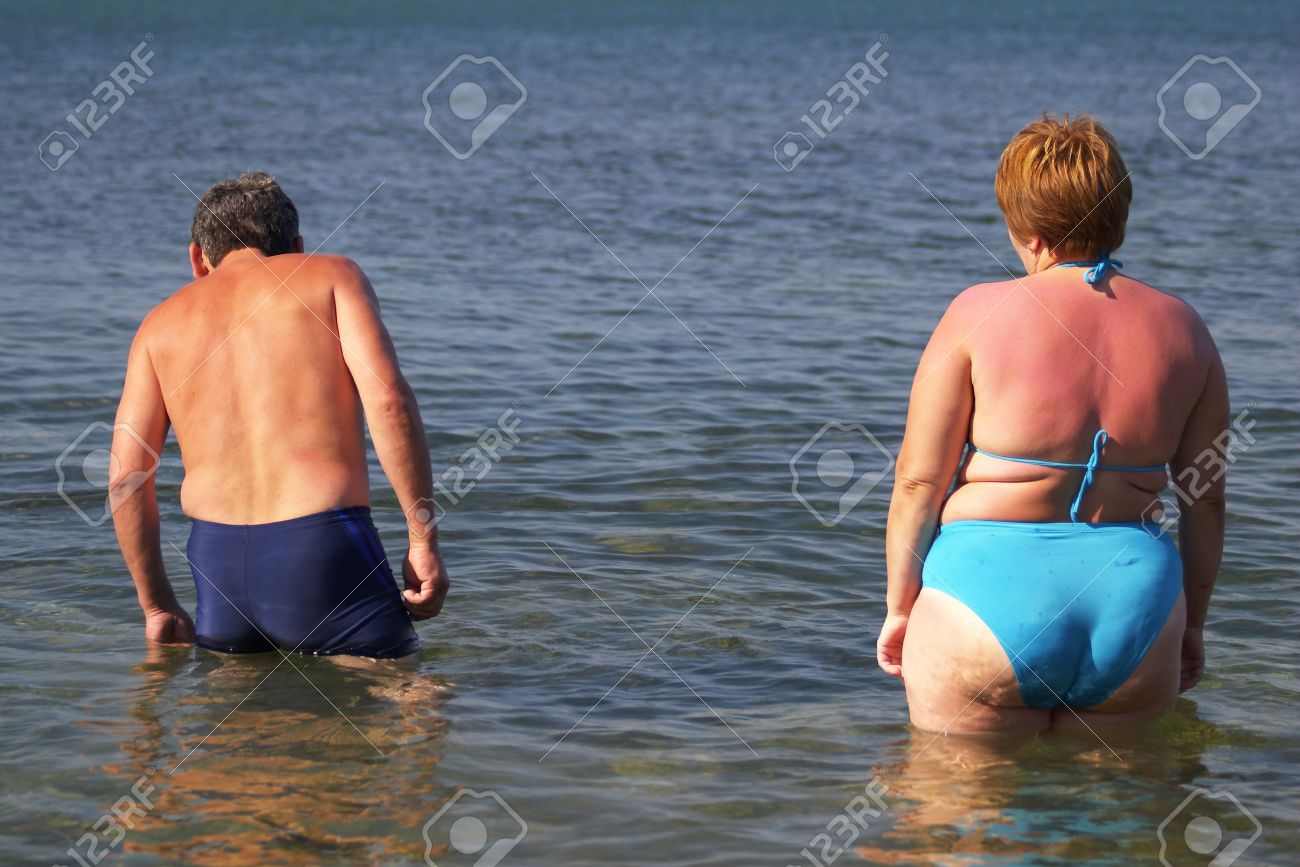 Woman Standing In The Sea Stock Photo