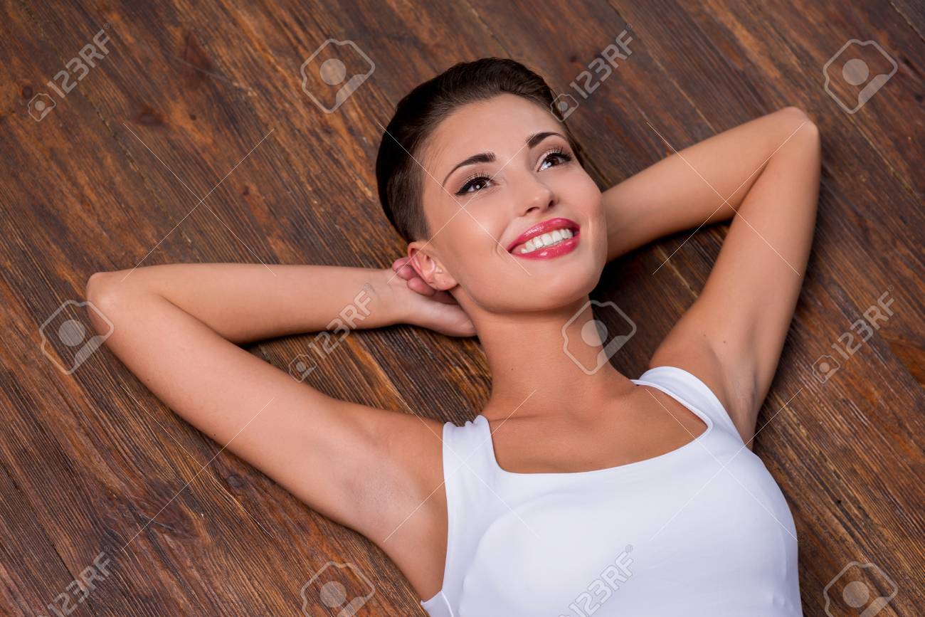 Top View Of Beautiful Young Short Hair Woman Holding Hands Behind