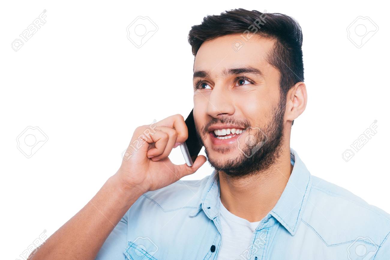 Good Talk With Friend Handsome Young Indian Man Talking On The Mobile Phone And Smiling While Standing Against White Background Stock Photo Picture And Royalty Free Image Image 48568683