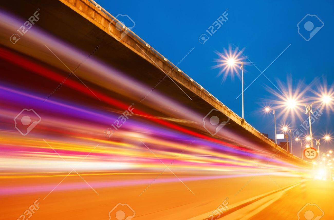High speed traffic and blurred light trails under the overpass at night scene - 12042694 High speed traffic and blurred light trails under the overpass at night scene - 12042694