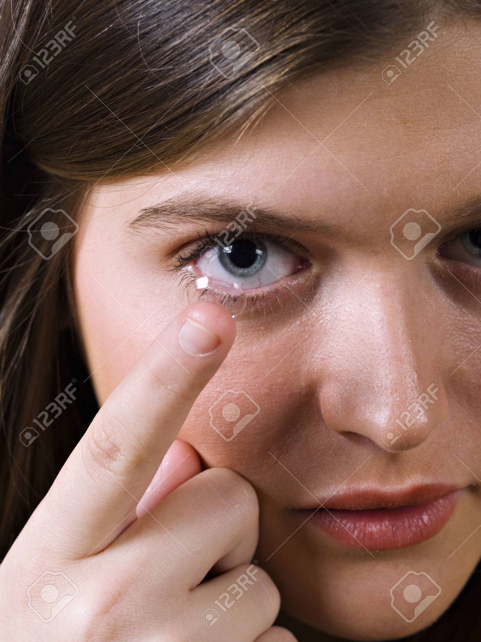 Close-up of blue woman eye with contact lens applying - 38156604 Close-up of blue woman eye with contact lens applying - 38156604