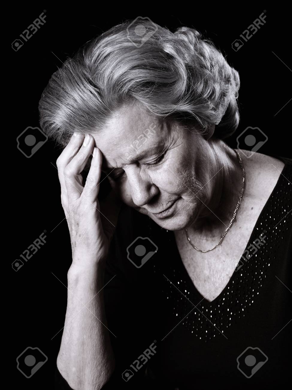 Elderly woman resting her head by having a pain - 38160269 Elderly woman resting her head by having a pain - 38160269