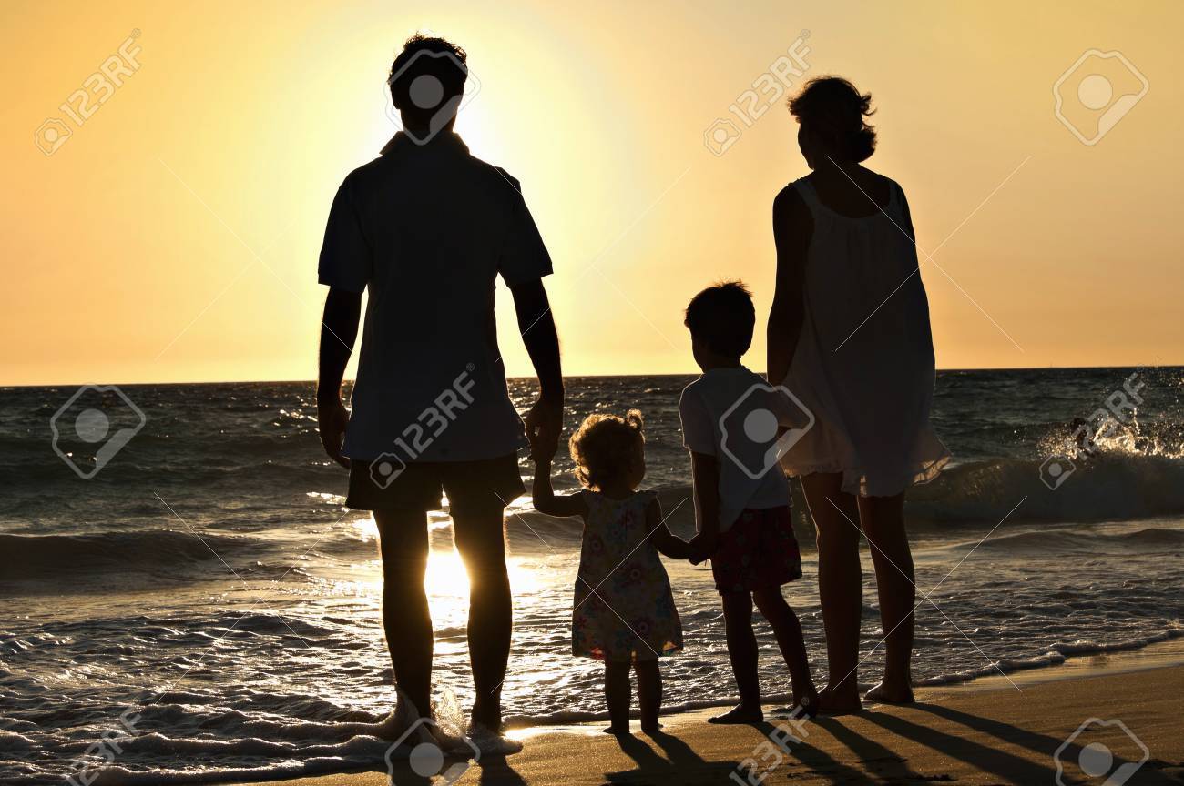 Family walking on the beach in sunset - 38161168 Family walking on the beach in sunset - 38161168
