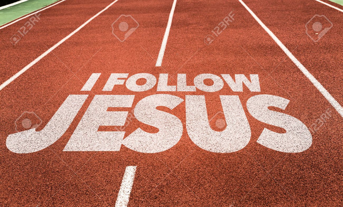 i follow jesus written on running track background stock photo